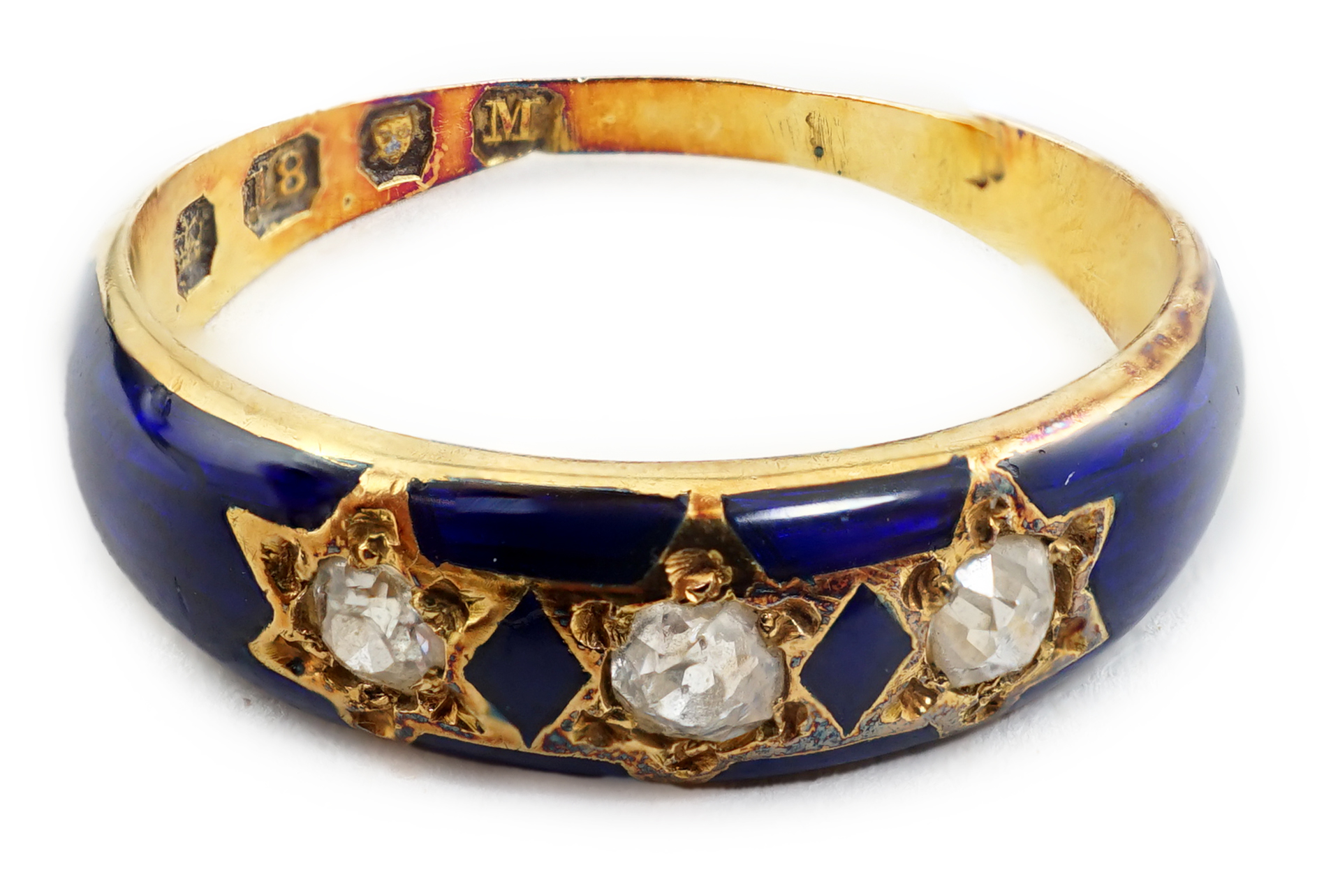 A late Victorian 18ct gold, three stone diamond and blue enamel set ring